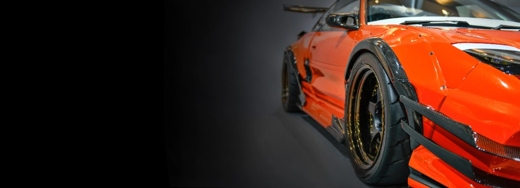 Orange widebody sports car with gloss vinyl wrap